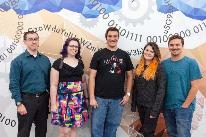 Two women and three men Enterprise Systems employees smile 